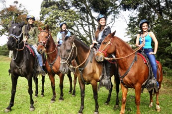 A group of guests pose on a horseback ride in Costa Rica